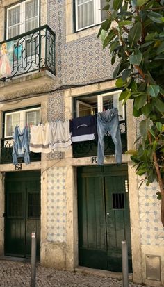 clothes hanging out to dry in front of an apartment building