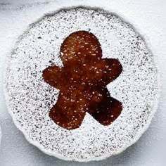 a powdered sugar cookie with an image of a gingerbread man on the top