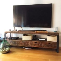 a flat screen tv sitting on top of a wooden entertainment center in a living room