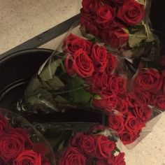 a bunch of red roses sitting on top of a counter