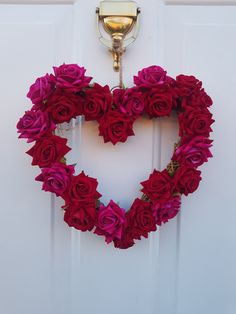 a heart shaped wreath hanging on the front door