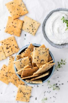 crackers and dip in a bowl on a table