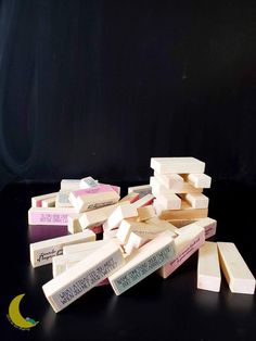 several blocks of white and pink soap on a black surface with a half moon in the background