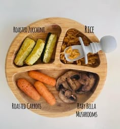 a wooden plate with different types of food on it and labeled in the words, baby carrots, broccoli, macaroni and cheese