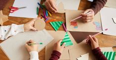 children are making christmas trees out of construction paper