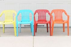 four plastic chairs lined up in front of a garage door