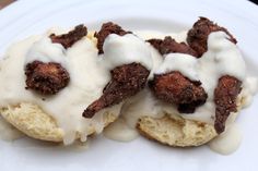 two donuts covered in icing on a white plate