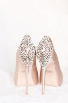 a pair of nude colored high heels with crystal embellishments