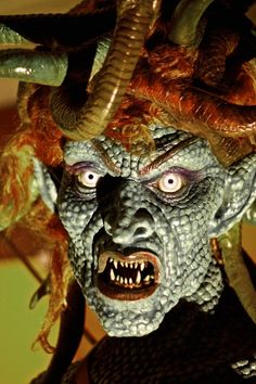 a close up of a person with horns on their head and demon like hair in front of them