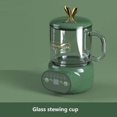 a green blender sitting on top of a counter next to the words glass stewing cup