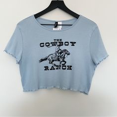 Cute Crop Top From Divided By H&M. Cotton Jersey. Round Neckline, Short Sleeves, And Overlocked Lettuce Trim Edges At Cuffs And Hem. Featuring A Cowboy Riding A Horse. Super Soft! Color: Light Blue Label Size: Xl Approximate Flat Lay Measurements: Width: 18.5” Length: 16” New With Tags! H&m Blue Tops For Summer, Trendy Blue H&m Tops, Casual Blue H&m Top, H&m Tops With Letter Print For Spring, Trendy H&m Tops With Letter Print, Blue Crew Neck Top From H&m, H&m Blue Summer Tops, Blue Crew Neck Tops By H&m, H&m Spring Tops With Letter Print