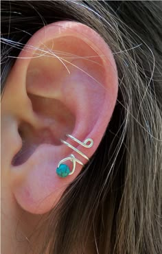 Simple Design wire-wrapped ear cuff with a small round turquoise semi-precious bead (3mm). Size/ Width: Approximately 1/2 inch with a 3mm opening (made to be worn on the middle part of the ear.) How to wear: The ear cuff is worn by sliding the opening down against the side of the ear towards the middle. To remove slide the cuff upwards.  Each cuff is made to order and will be wrapped in a gift box. Select a finish for your cuff in Sterling Silver or 14k gold-filled. Minimalist Adjustable Wire Wrapped Wrap Earrings, Adjustable Sterling Silver Wire Wrapped Ear Cuff, Unique Adjustable Wire Wrapped Cartilage Earrings, Simple Earring Designs, Ear Cuff Diy, Simple Ear Cuff, Wire Ear Cuffs, Wire Wrapped Turquoise, Ear Cuff Jewelry