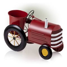 a toy tractor with a bucket on the front and wheels, is shown against a white background