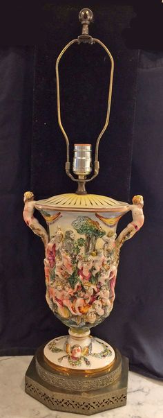 an ornate vase is sitting on top of a stand