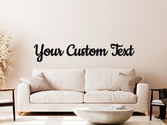 a white couch sitting next to a wall with the words your custom text on it