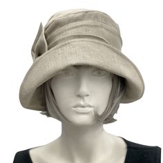 This is the Alice shown here in a pale gray Linen , in true Downton Abbey Style . The ever gorgeous Alice is stylish, elegant and Oh so Comfortable! Alice is styled on the designs from the flapper period. A time in the 1920's and 30's when hats were a MUST.Look the part, whether it be a vintage inspired occasion or one where you want to look and feel polished, finished and have that "wow" factor. Wear your Alice with pride and distinction on your next cruise or even your walk along the beach Mad Classic Gray Hat For Spring, Classic Gray Hats For Spring, Classic Gray Spring Hat, Fitted Beige Cloche Hat, Classic Spring Cloche Hat, Classic Beige Cloche Hat With Flat Brim, Fitted Beige Brimmed Cloche Hat, Linen Hat With Short Brim, Classic Fitted Cream Cloche Hat