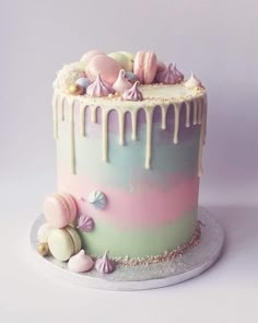 there is a colorful cake with icing on the top and shells on the bottom