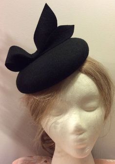 Currently Ready to ship - ship out in 3-5 days. OVERVIEW -------------- This design was inspired by those of Duchess of Cambridge - Kate Middleton's fascinators. This hat would look much better if you wear it on the right side of the head. DETAILED DESCRIPTION --------------------------------- This listing is for a chic handmade 100% Merino wool fascinator hat in BLACK color. It features a cute looped bow - full of elegance and character.  I could make this design in more than 100 colors, just message me or leave me a note during checkout.  Wool fascinators are not just for the royalty or the high society. Everyone looks at their best wearing them and they are appropriate on nearly all occasions. They are not flashy or swanky: instead, they are the embodiment of a timeless elegance back in Handmade Formal Hats, Handmade Fitted Hats For Formal Occasions, Handmade Fitted Formal Hats, Formal Fitted Handmade Hats, Fitted Black Hat With Structured Crown, Handmade Fitted Vintage Fascinator, Winter Brimmed Fitted Fascinator, Winter Curved Brim Fitted Fascinator, Black Hats For Winter Races