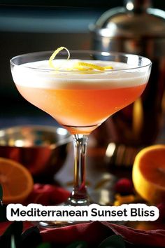 a close up of a drink in a glass with an orange slice on the rim