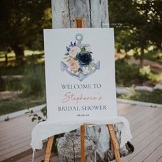 a welcome sign for a bridal shower on a wooden easel in front of a tree