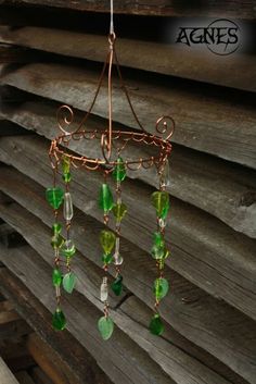 a wind chime with green glass beads hanging from it