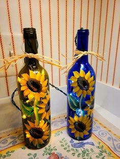 two bottles with sunflowers painted on them