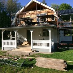 a house being built in the middle of a yard with lots of wood on it