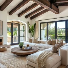 a living room with couches and large windows