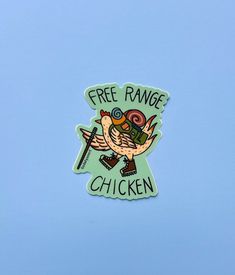 a sticker with the words free range chicken on it's back and an image of a bird holding a camera