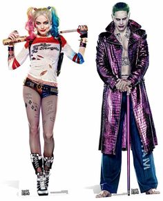 two male and female clowns dressed in costumes with different hair colors, makeup and piercings