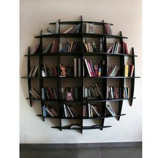 the bookshelf is made out of black wood and holds many different types of books