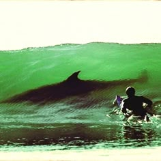 a man riding a wave on top of a surfboard