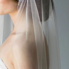 a woman wearing a veil with her hair pulled back