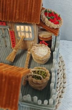 there are many pies and other food items in this miniature model house on display