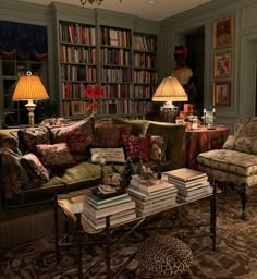 a living room filled with lots of furniture and bookshelves full of books on top of them