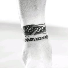 a black and white photo of a person's foot with a tattoo on it