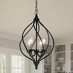 a chandelier hanging from the ceiling in a kitchen