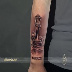 a tattoo on the arm of a person with a chess piece