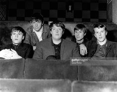 the beatles posing for a group photo in their seats at an event, circa 1950