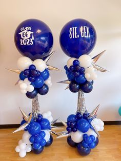 two blue and white balloons with stars on them