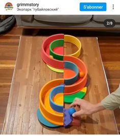 someone is playing with colorful plastic rings on the floor