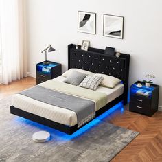 a bedroom with a bed, night stand and two nightstands on either side of the bed