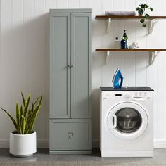 a washer and dryer are next to each other in a room with white walls