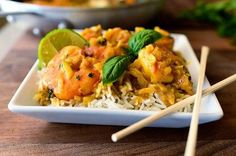 a white plate topped with rice and chicken