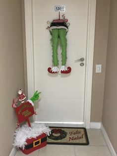 the door is decorated for christmas with santa's helper and elf legs on it