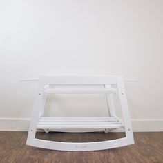 a white shelf sitting on top of a hard wood floor next to a white wall