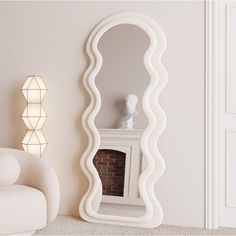 a large white mirror sitting on top of a floor next to a chair and fireplace