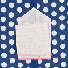 a piece of fabric with white polka dots on it and a pink patch in the middle