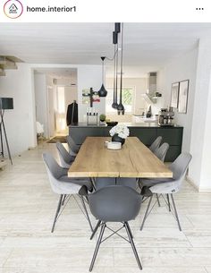 a dining room table with grey chairs and an island in the middle is surrounded by white tile flooring