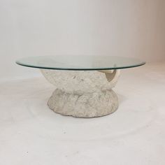 a glass table sitting on top of a white floor